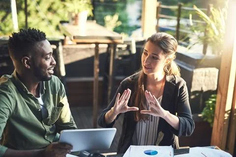 Developing a new design together. two designers having a meeting at a coffee Stock Photos
