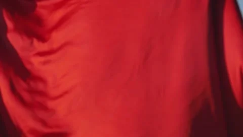 Developing red silk cloth against the background of the field. Stock-Footage 152497200