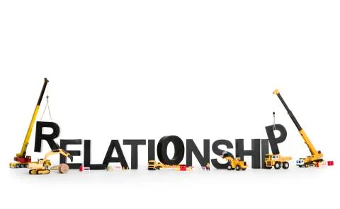 Developing a relationship: Machines building word. Stock Photos