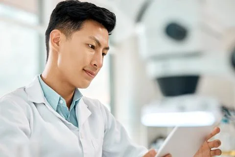 Developing research on a new case. a young scientist using a digital tablet in a Stock Photos