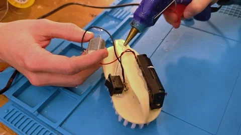 Developing scientific technical creativity. A child designs a moving toy car. Stock Footage 291709579