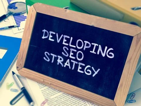 Developing SEO Strategy Handwritten on Chalkboard Stock Illustration