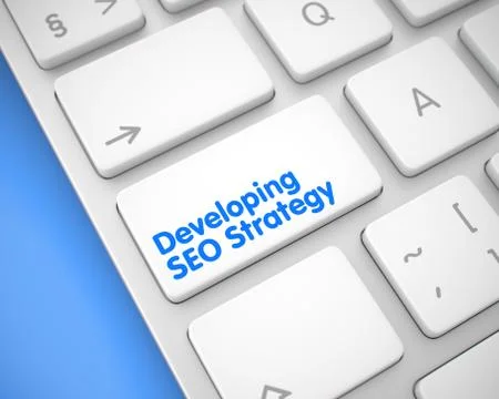Developing SEO Strategy - Text on the White Keyboard Keypad. 3D Illustrazione stock