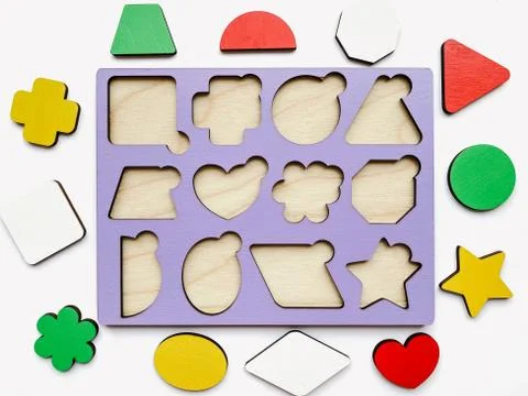 The developing toy an insert consisting of geometric figures isolated on whit Stock Photos