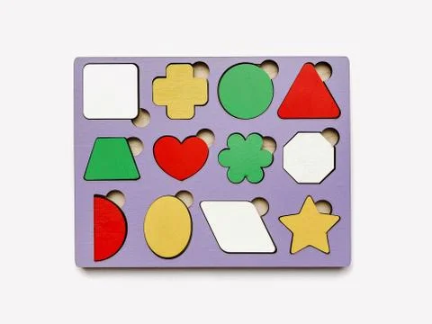 The developing toy an insert consisting of geometric figures isolated on whit Stock Photos