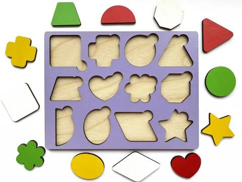 The developing toy an insert consisting of geometric figures isolated on whit Stock Photos