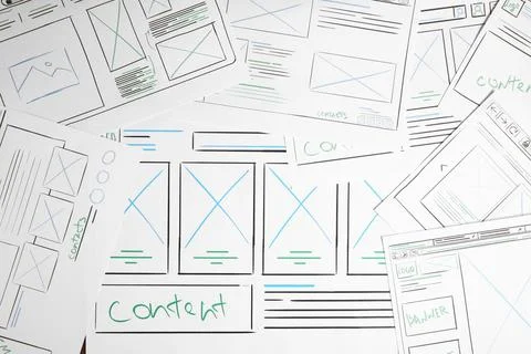 Developing UI design. Sketches of website wireframes on as background, top vi Stock Photos