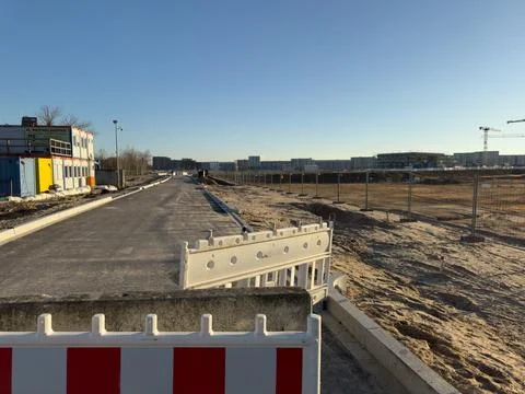 Developing urban area with new road and construction site Stock Photos