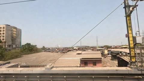 Developing urban scene featuring construction site, tall structures, palm Video stock 293763373
