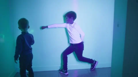 Development and learning of children, happy child plays in interactive room with Stock Footage 204930425