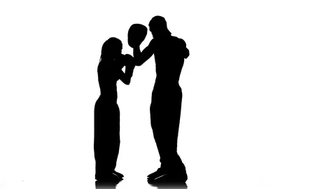 Development of straight kicks kickboxing on boxing paws. Silhouette. White Stock Footage 92444838