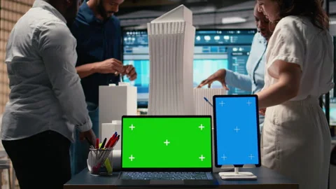 Development team evaluates 3D building models next to copy space Stock Footage 316645855