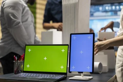 Development team evaluates 3D building models next to copy space Fotos de archivo