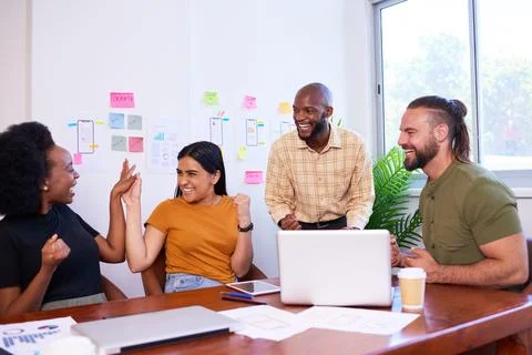 Development team members high five and celebrate, launch of new app success Stock Photos