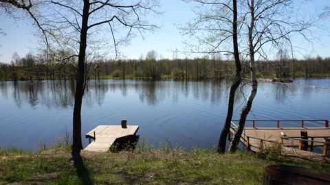 Development of the territory of the fishing lake. Spring nature. Family vacation Stock Footage 274413853