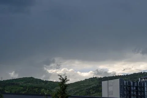 Development of thunderstorm clouds over hilly landscape cumulonimbus clouds.. Stock Photos