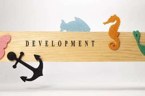 Development written on wood patterned surface. Education and child psychology Stock Photos