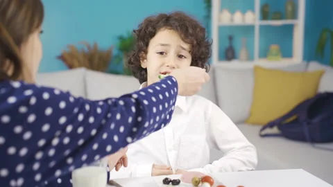 A developmental boy is having breakfast with his sahab mother and they are happy Stock Footage 228826586