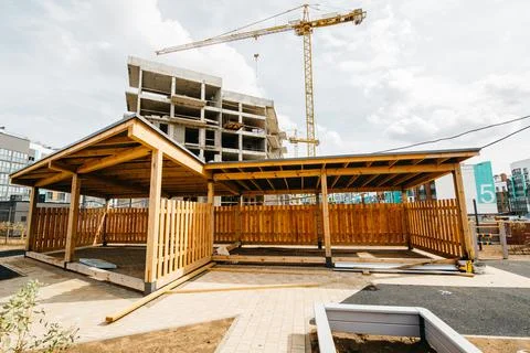Developmental playground with construction cranes and site in the background Stock Photos