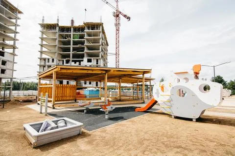 Developmental playground with construction cranes and site in the background Stock Photos