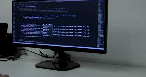 Develper writing sql code in monitor working from home Stock Footage 228578421