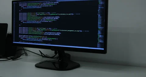 Develper writing sql code in monitor working from home Stock Footage 243624037