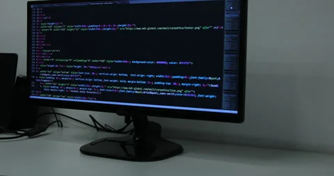 Develper writing sql code in monitor working from home Stock Footage 243624067