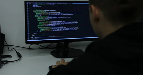 Develper writing sql code in monitor working from home Stock Footage 243624213