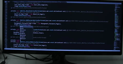 Develper writing sql code in monitor working from home Stock Footage 243624468
