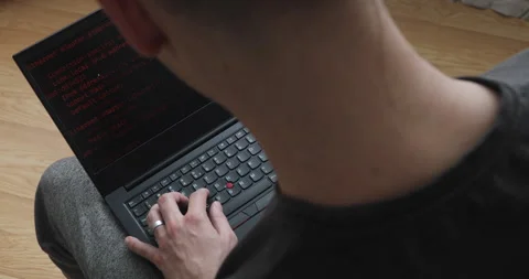 Develper writing sql code in monitor working from home Stock Footage 243624751