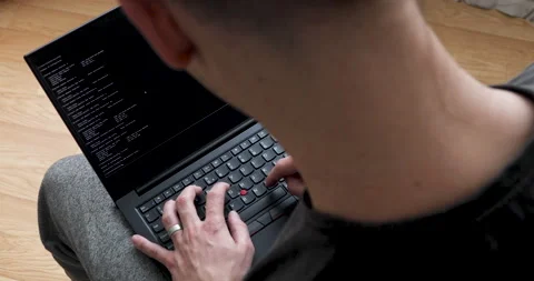 Develper writing sql code in monitor working from home Stock Footage 243624754