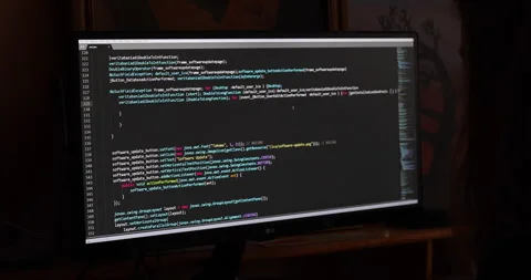 Develper writing sql code in monitor working from home Stock Footage 243624876
