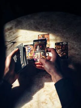 Deviant Moon Tarot Cards Spread in Hands Stock Photos