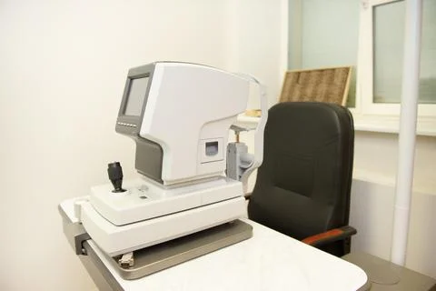 The device for checking the vision of a person is in the office of an optomet Stock Photos