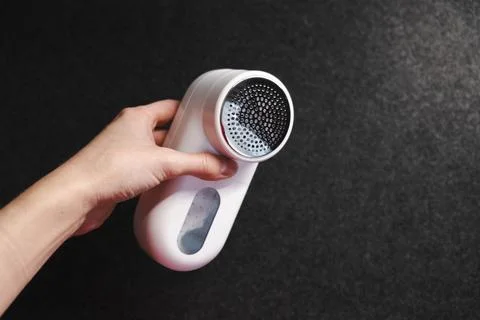 Device for cleaning clothes from pellets. Stock Photos