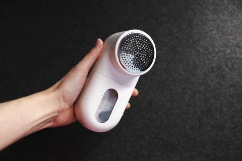 Device for cleaning clothes from pellets. Stock Photos