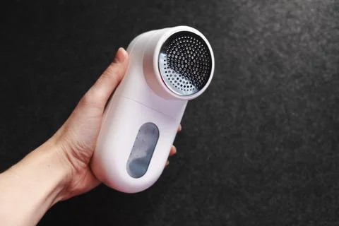 Device for cleaning clothes from pellets. Stock Photos