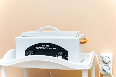 Device for deep sterilization of hairdressing tools in real conditions of a b Stock Photos