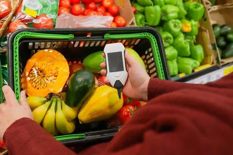 Device in hand measuring nitrates and pesticides on market vegetables and fruits Stock Photos