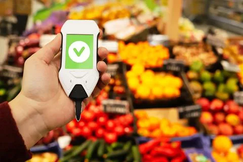 Device in hand measuring nitrates and pesticides on market vegetables and fruits Stock Photos