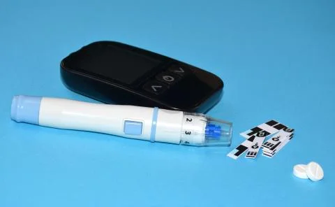 The device for measuring blood sugar on the table.	 Stock Photos