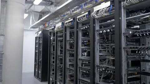 Device for mining crypto currency. Row of bitcoin miners set up on the wired Stock Footage