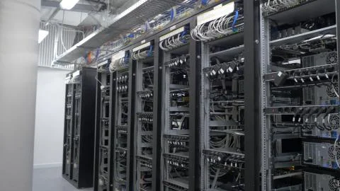 Device for mining crypto currency. Row of bitcoin miners set up on the wired Stock Photos