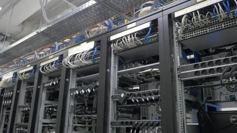 Device for mining crypto currency. Row of bitcoin miners set up on the wired Stock Photos