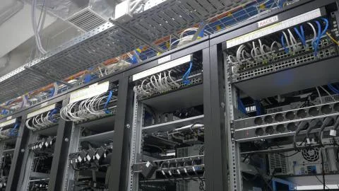 Device for mining crypto currency. Row of bitcoin miners set up on the wired Stock Photos