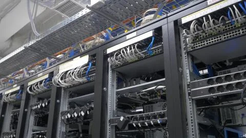 Device for mining crypto currency. Row of bitcoin miners set up on the wired Stock Photos