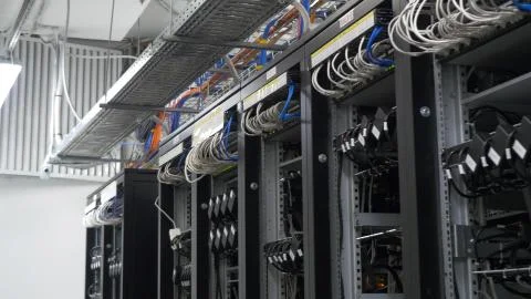 Device for mining crypto currency. Row of bitcoin miners set up on the wired Stock Photos