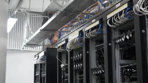 Device for mining crypto currency. Row of bitcoin miners set up on the wired Stock Photos