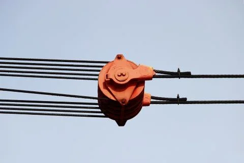 The device of a red loader on the railway. Block system against the blue sky. Stock Photos