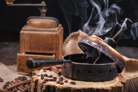 The device for roasting coffee beans, an old hand grinder. Photos